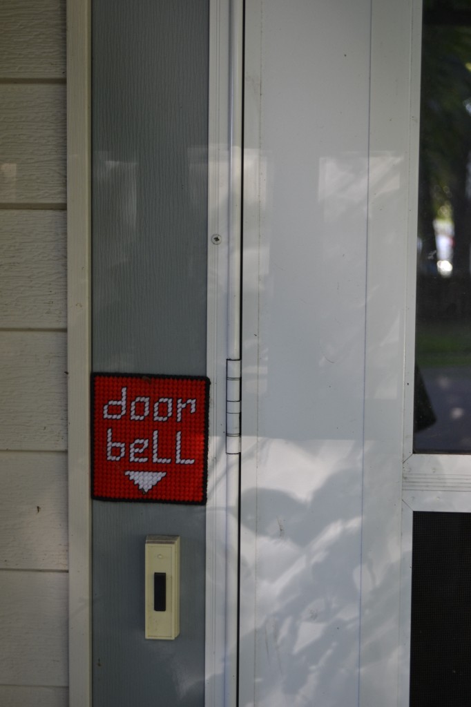 cross-stitched doorbell label